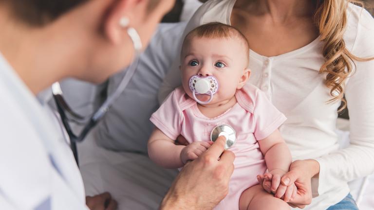 doctor listening to a baby's heartbeat