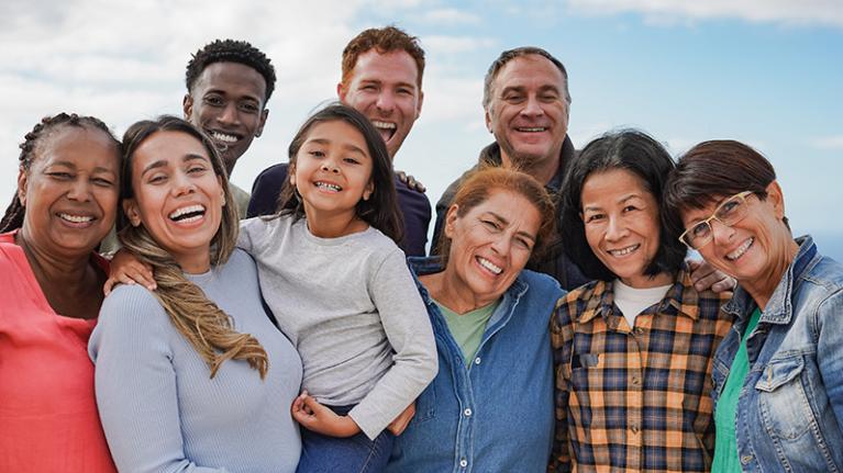 a group of smiling people of various ages and nationalities