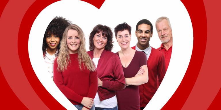 People wearing red under a heart shaped frame