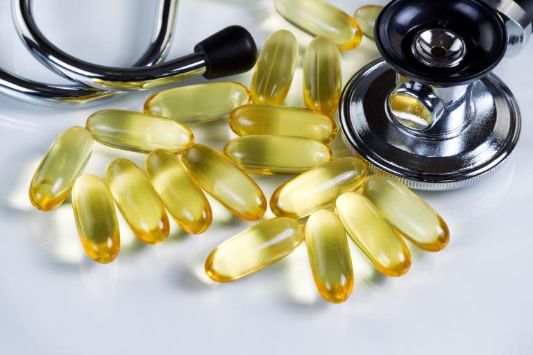 Photo of fish oil capsules next to stethoscope. Source: Shutterstock